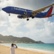 AI generated image of plane landing over beach